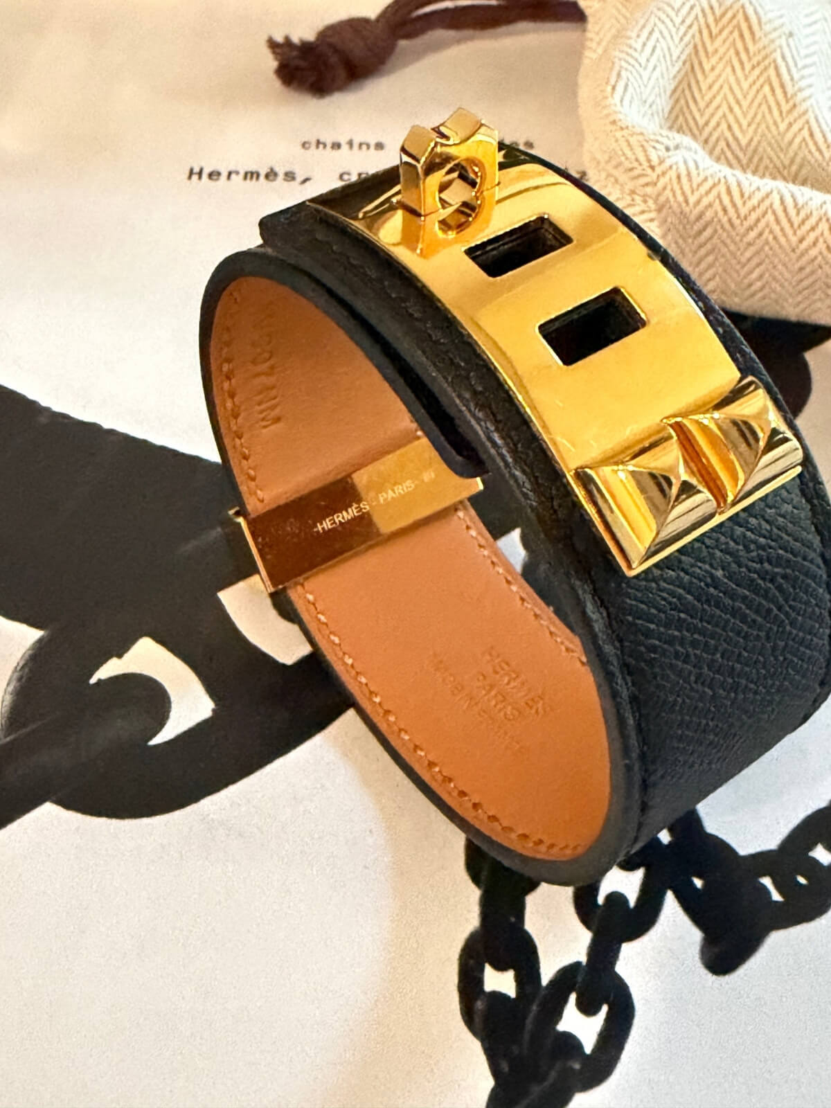 Louise Row featuring Hermes Collier Cuff 24 in black leather on table