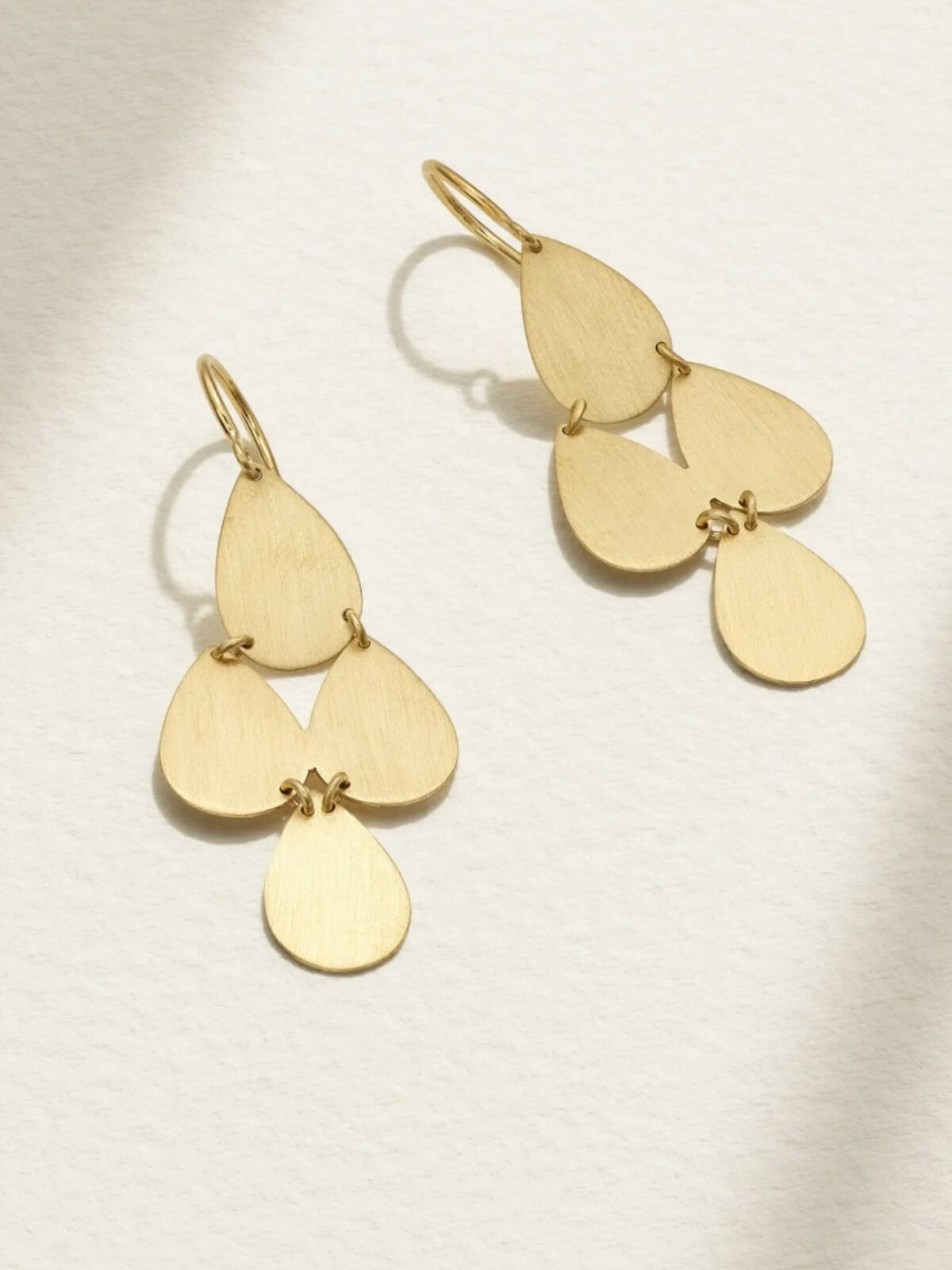 Gold chandelier earring on white background