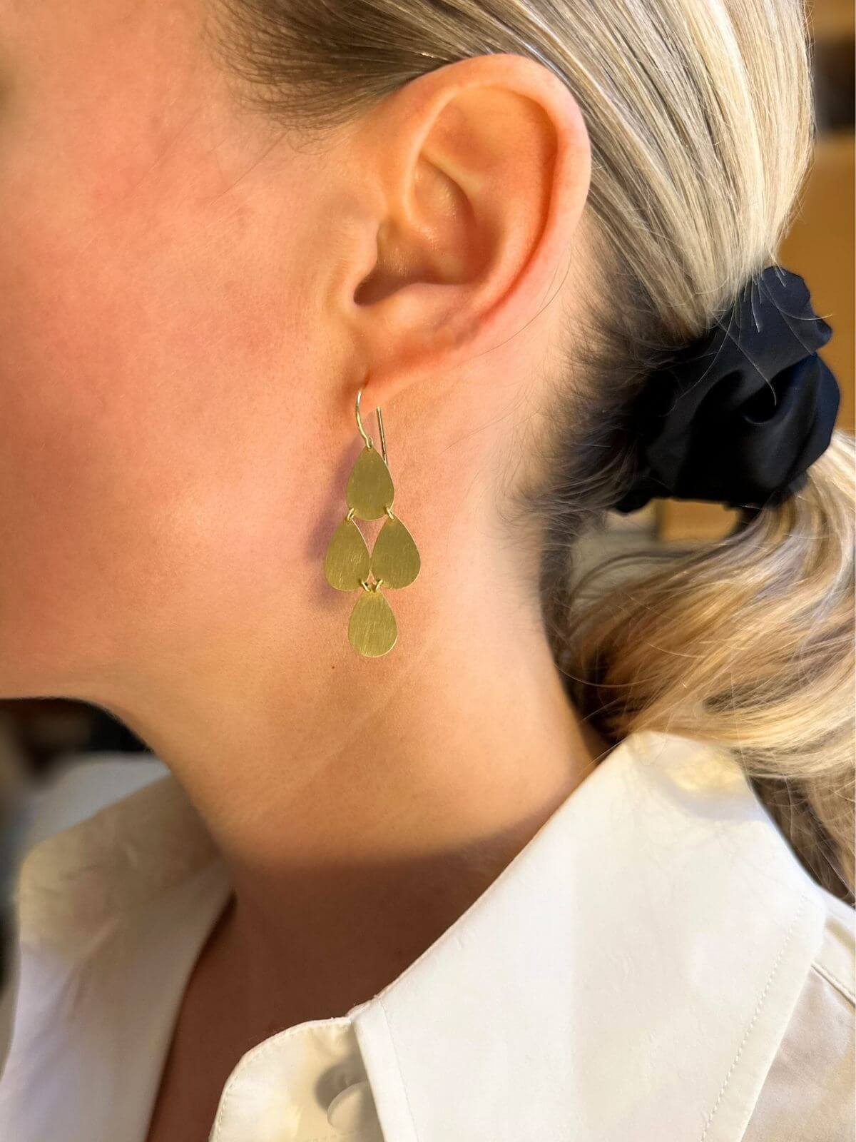 Model in gold chandelier earring