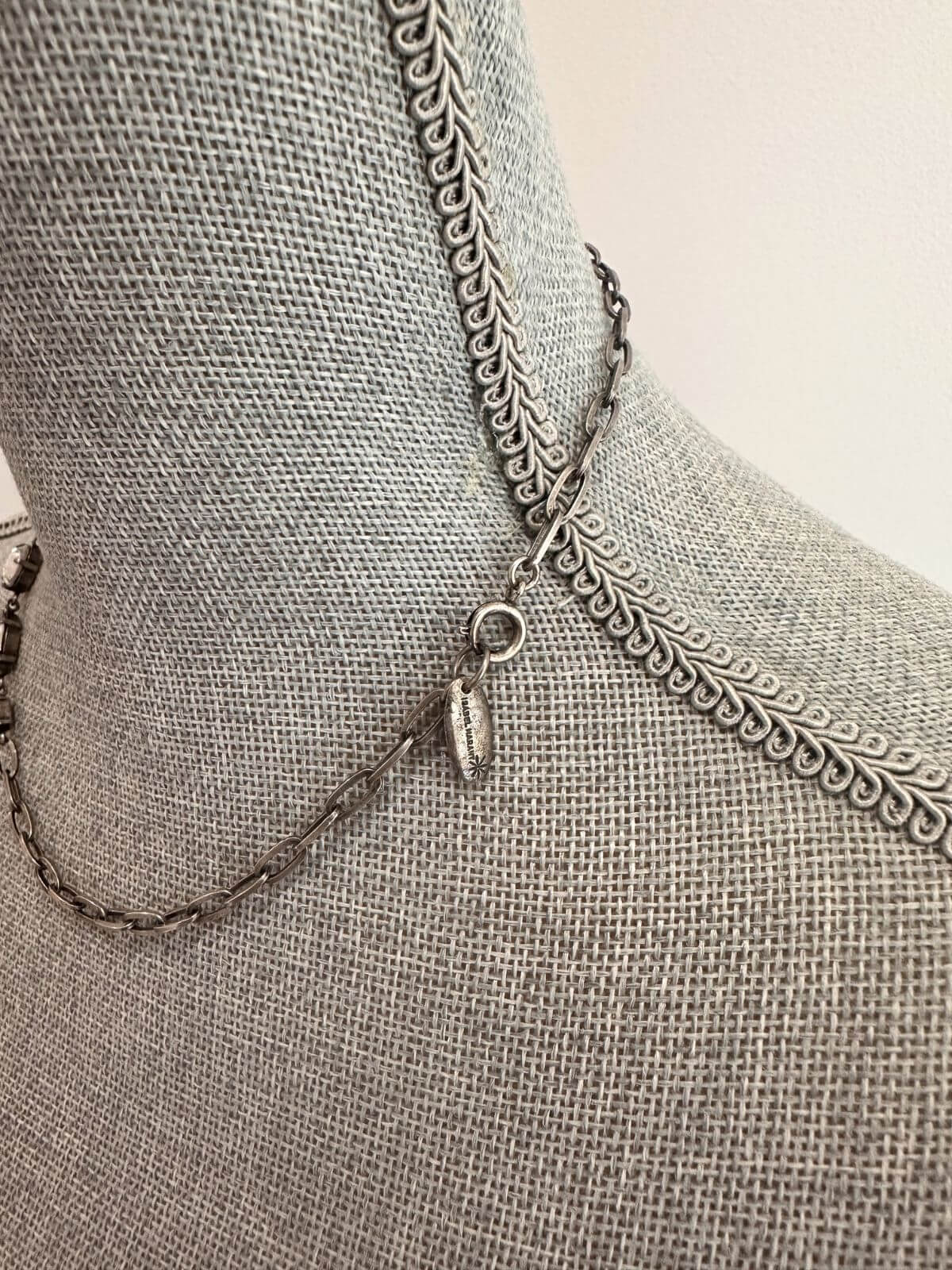 Louise Row Studio featuring Isabel Marant Necklace with crystals on grey neck mannequin. Showing detail.