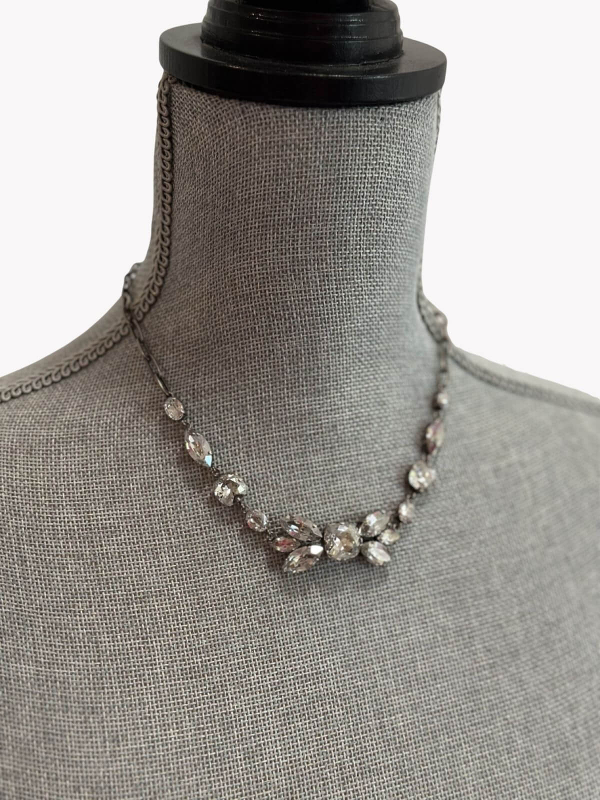 Louise Row Studio featuring Isabel Marant Necklace with crystals on grey neck mannequin.