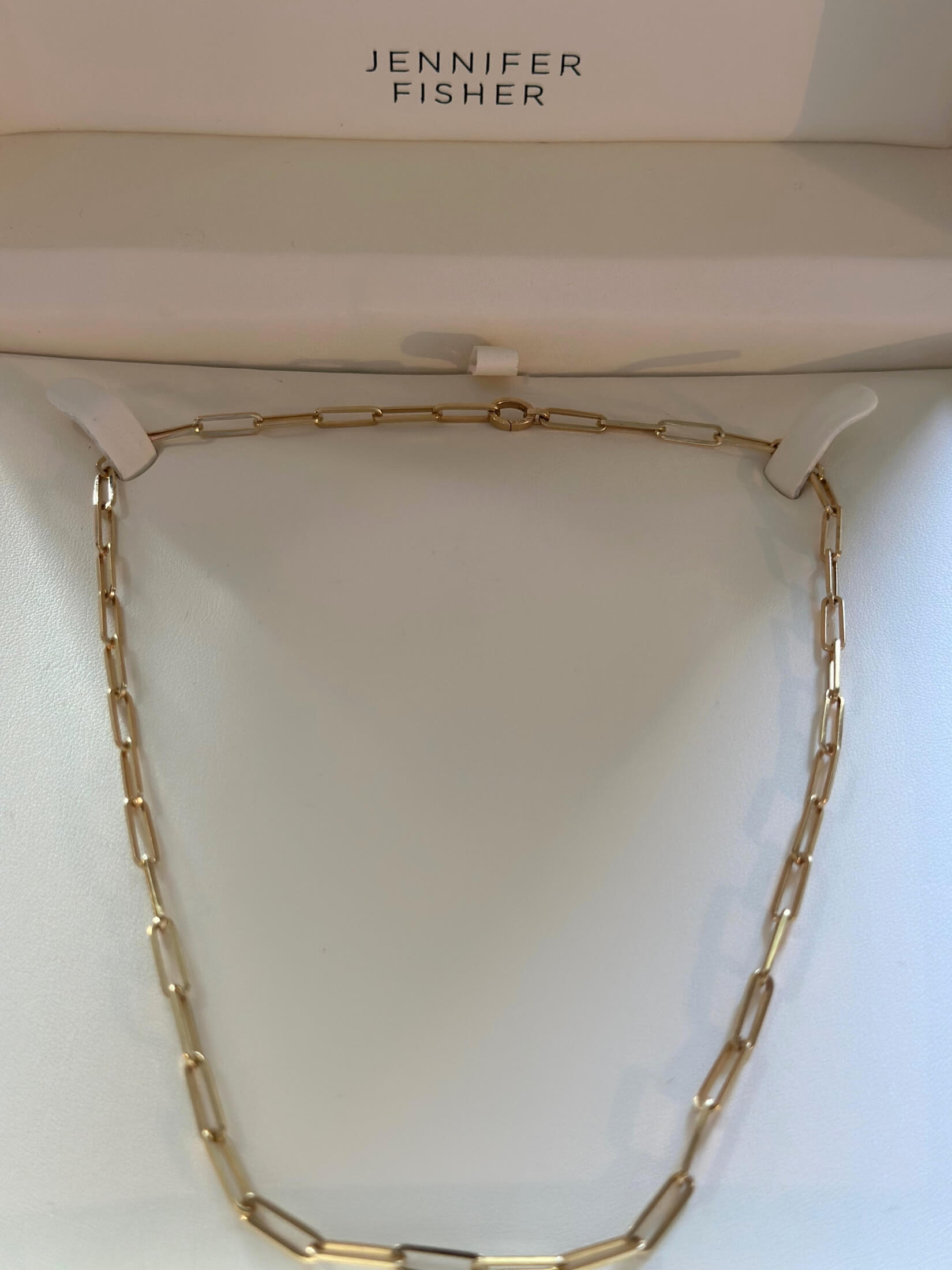 Louise Row featuring Jennifer Fisher gold paperclip necklace in box on table
