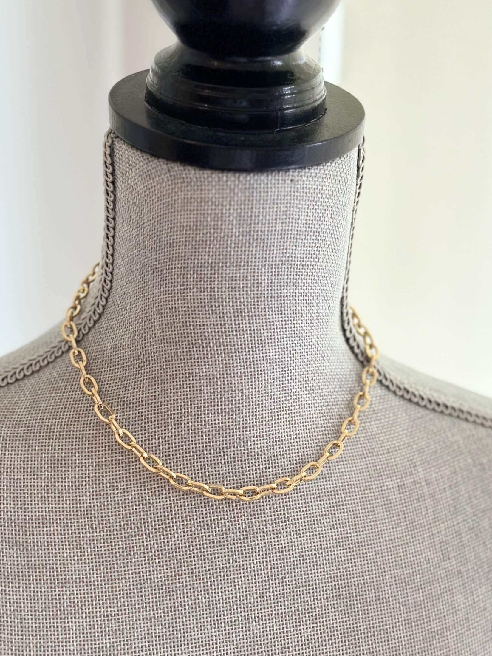 Louise Row featuring Jennifer Fisher XXS gold link chain on grey mannequin