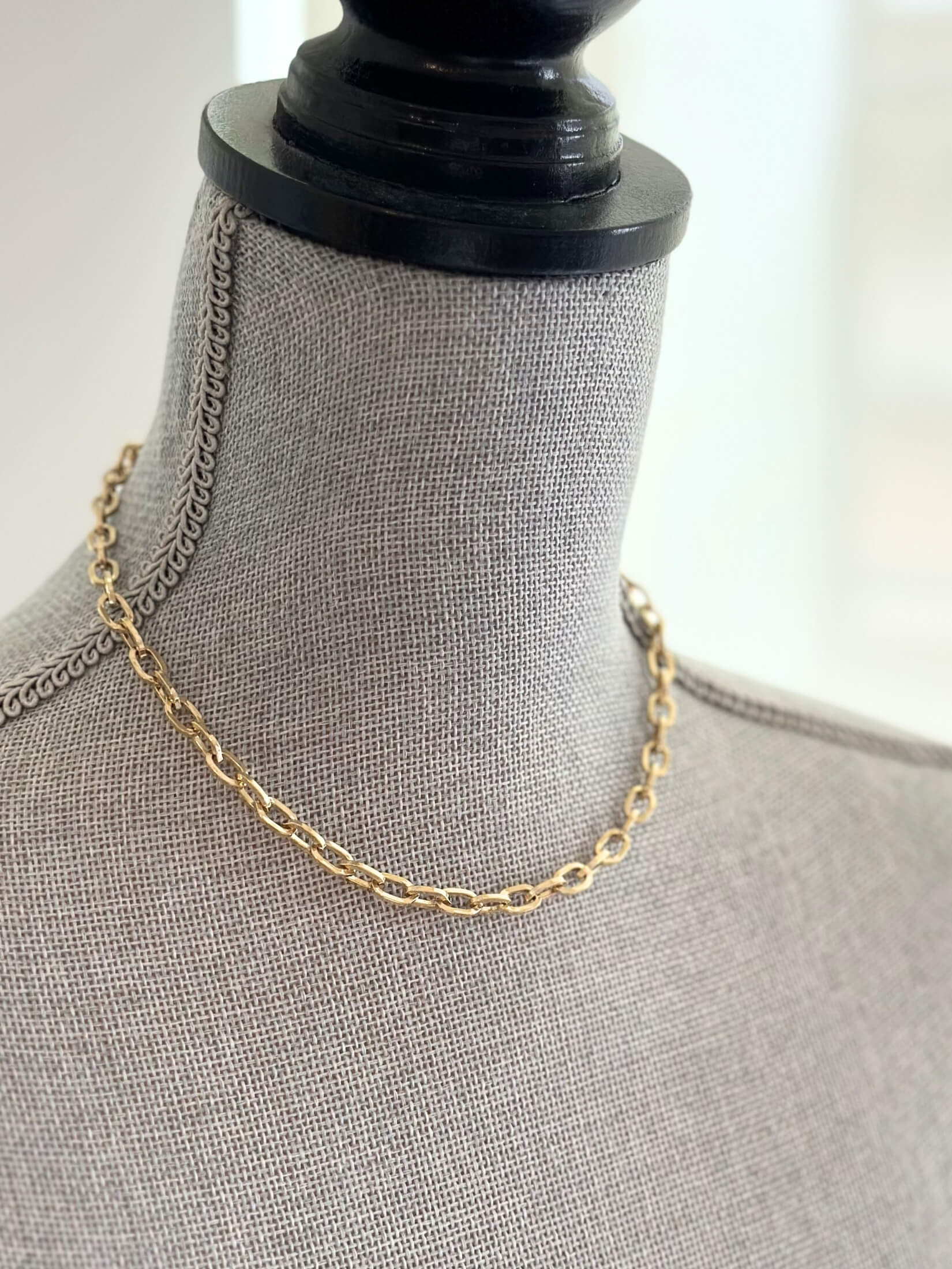 Louise Row featuring Jennifer Fisher XXS gold link chain on grey mannequin
