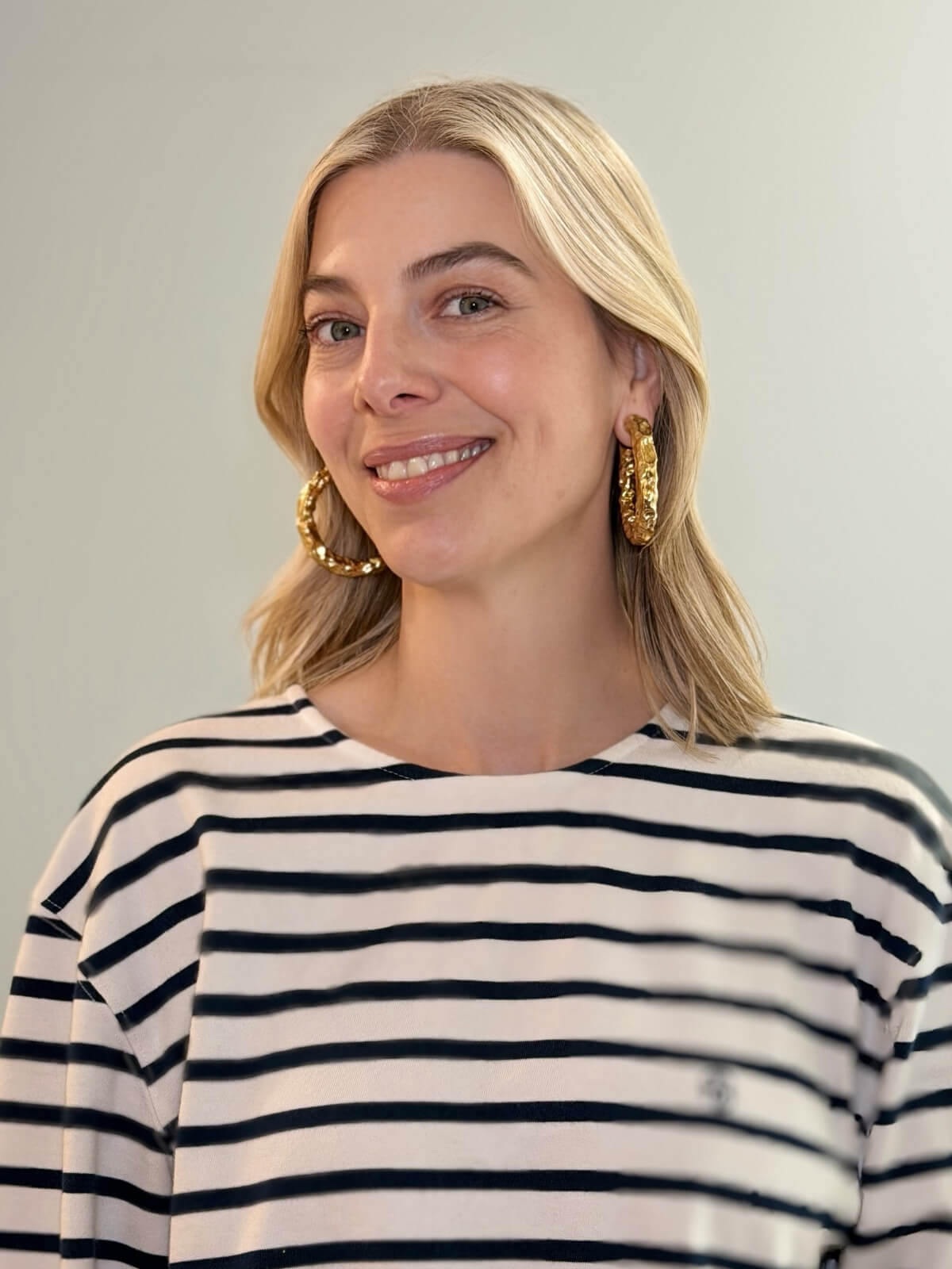 Louise Row featuring model wearing Jennifer Fisher gold hoop.