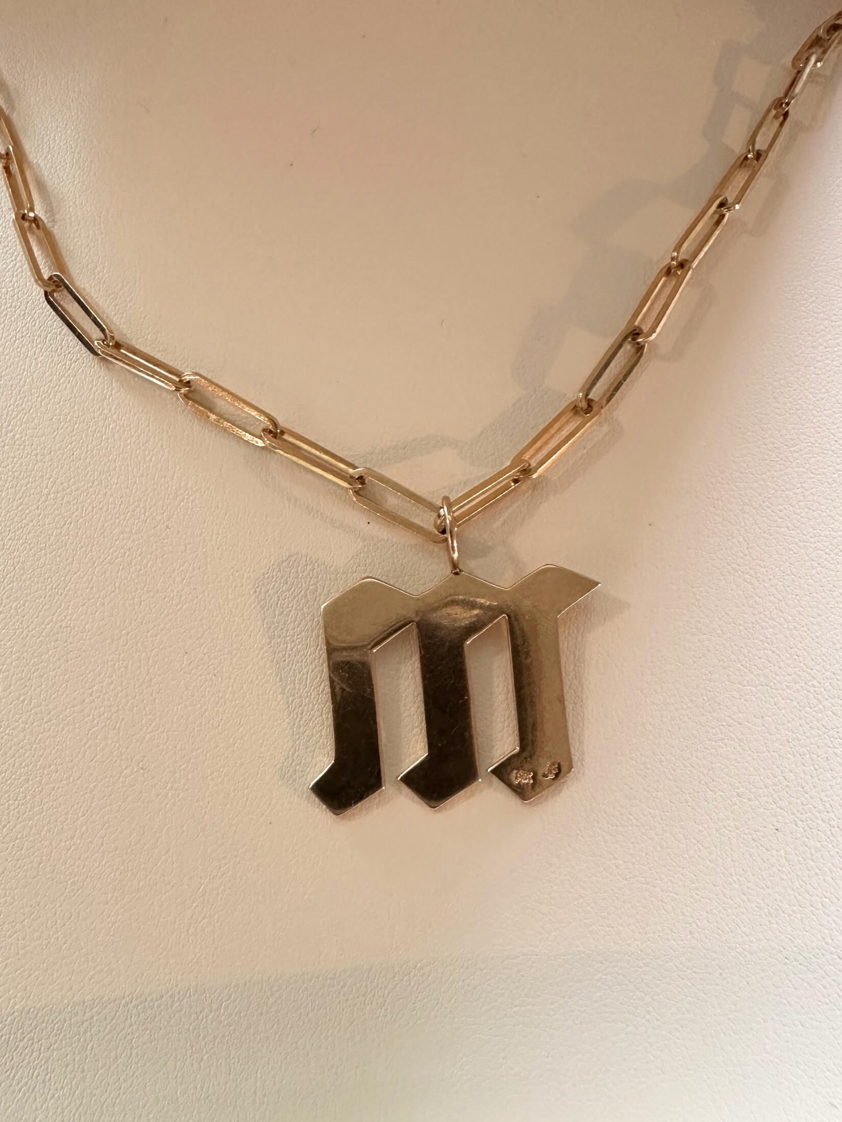 Louise Row featuring Jennifer Fisher M charm on necklace in box