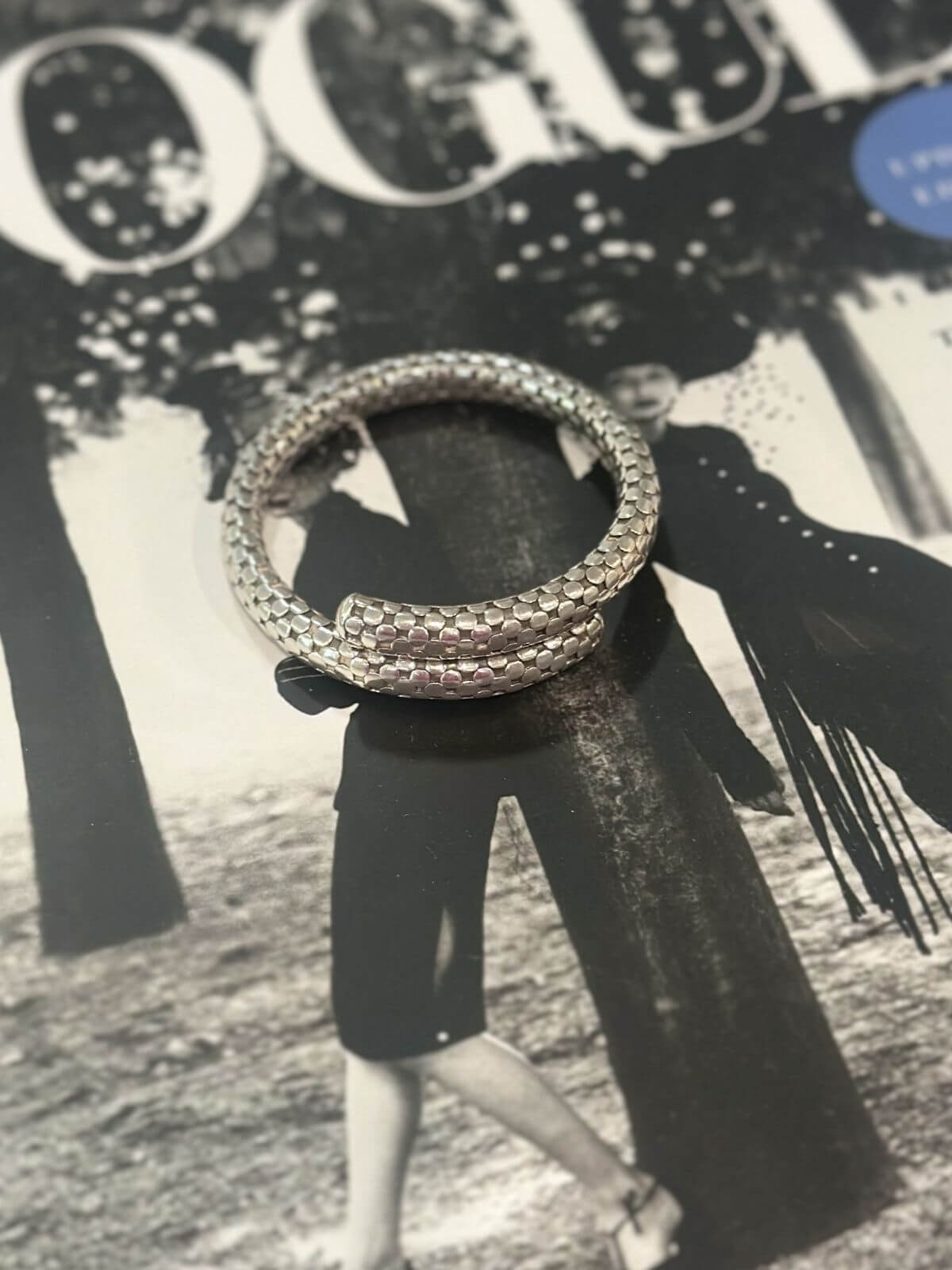 Louise Row Studio featuring John Hardy silver Dot single coil bracelet on vogue black and white book.