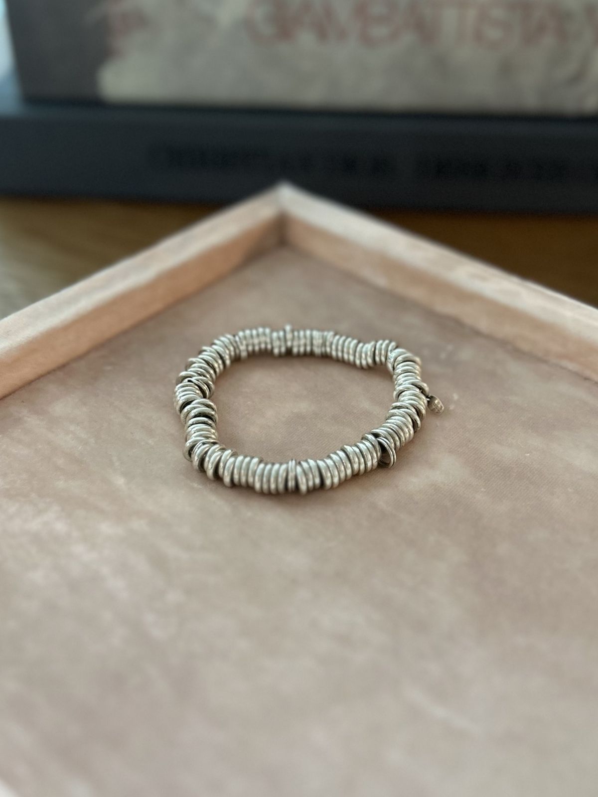 Silver Link of London Sweetie bracelet on pink background