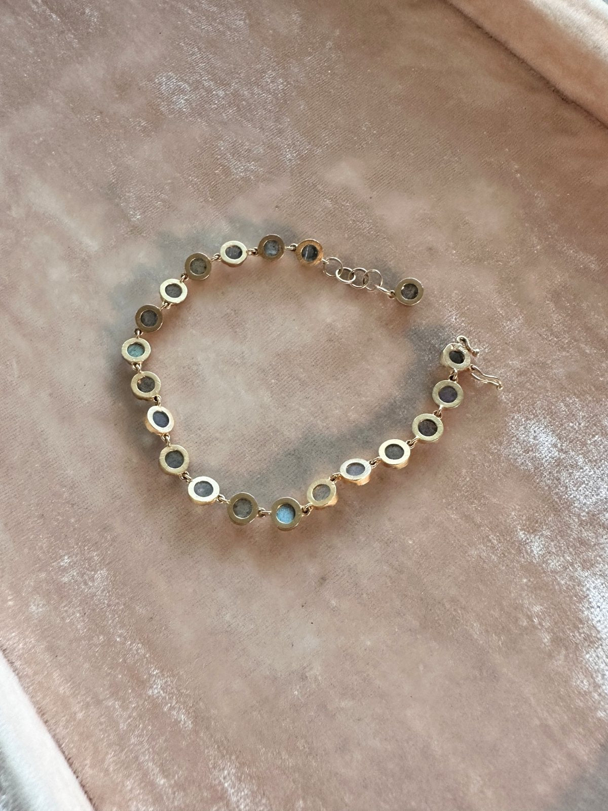 Louise Row Studio featuring custom Labradorite bracelet on pink pad. Back side.