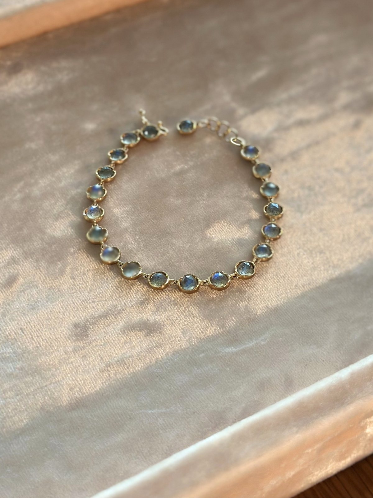 Louise Row Studio featuring custom Labradorite bracelet on pink pad.
