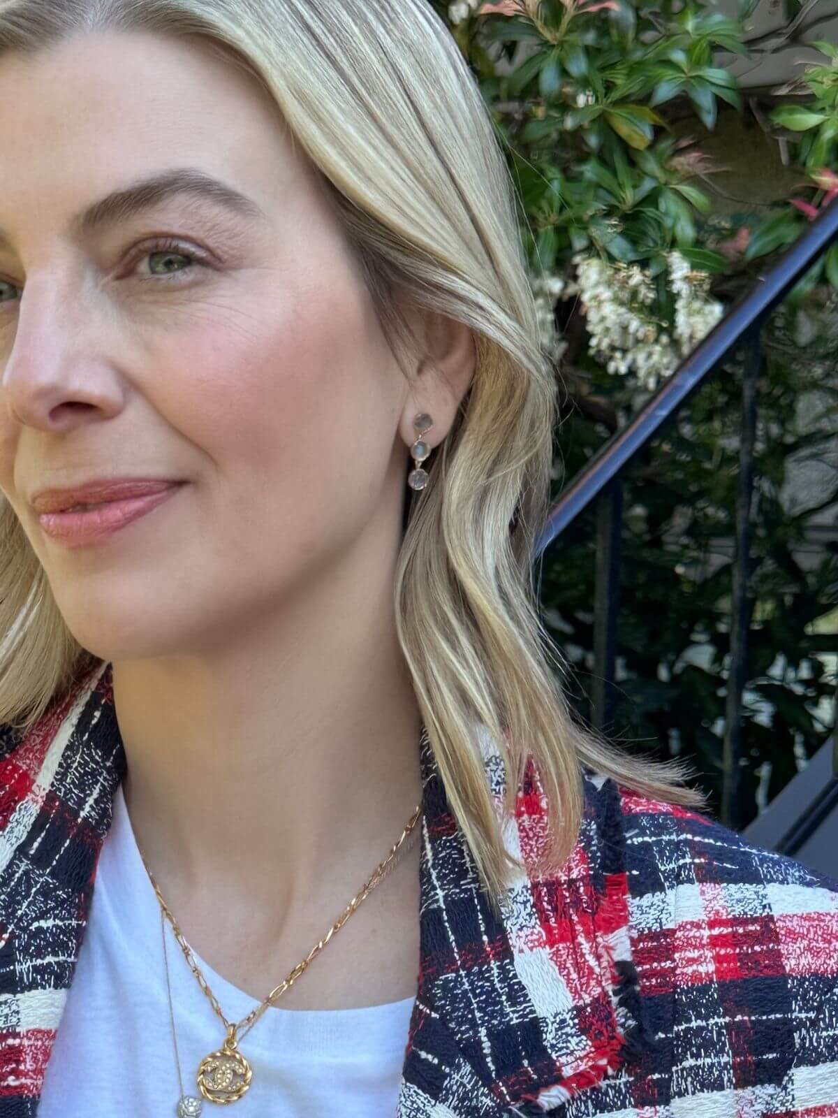 Louise Row Studio earrings, model wearing 3 drop 18K labradorite stone drop earrings with blonde hair wearing a plaid jacket outdoors