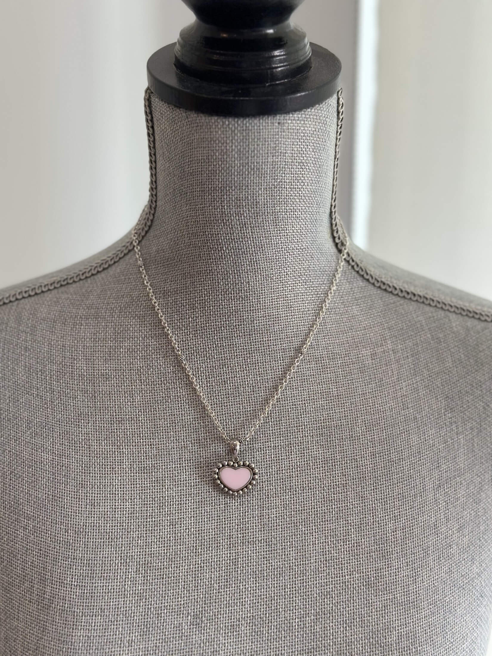 Louise Row featuring Lago pink ceramic heart necklace on grey mannequin