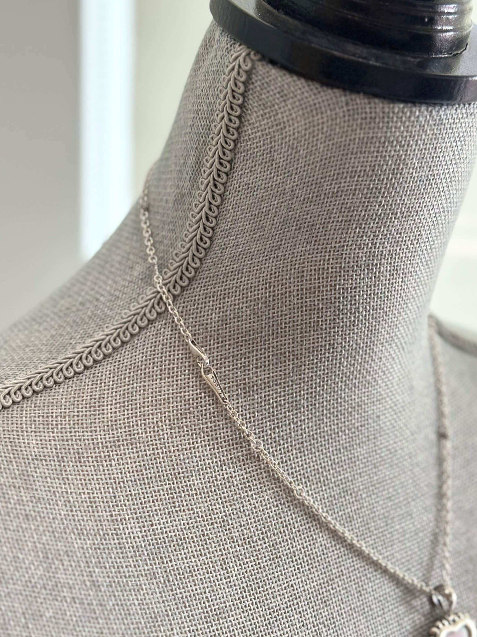 Louise Row featuring Lago pink ceramic heart necklace on grey mannequin