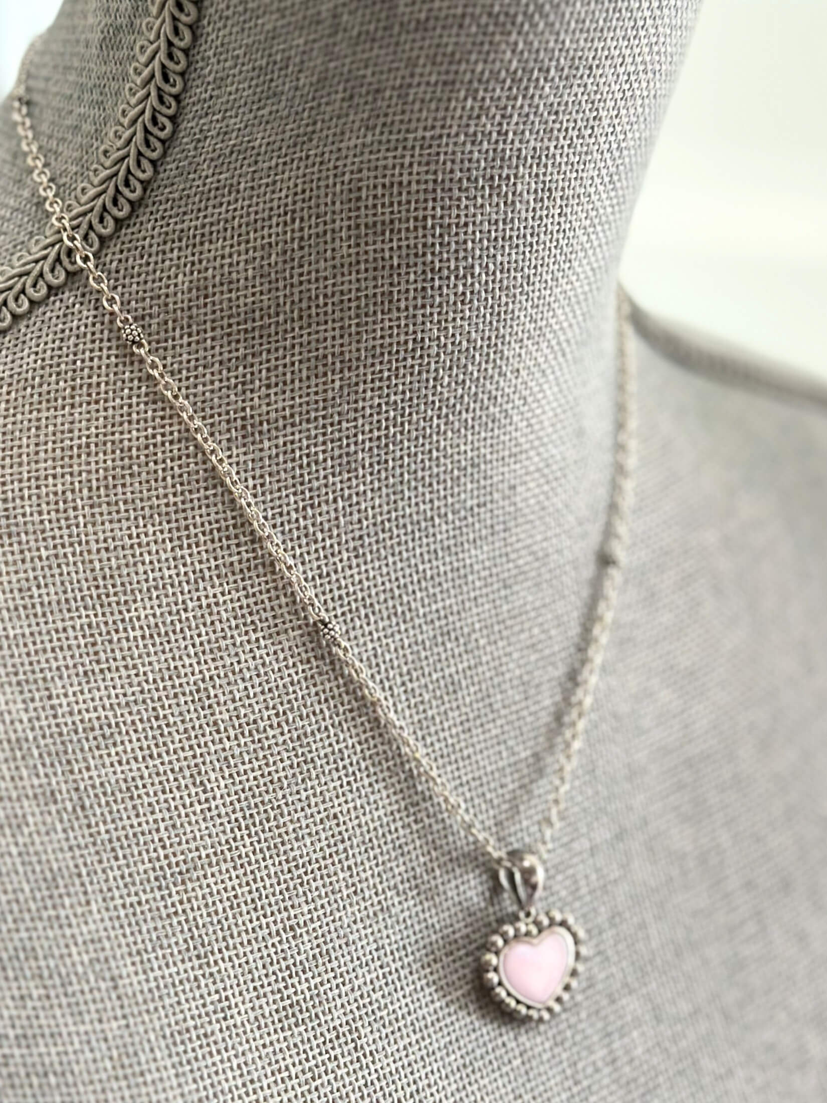 Louise Row featuring Lago pink ceramic heart necklace on grey mannequin
