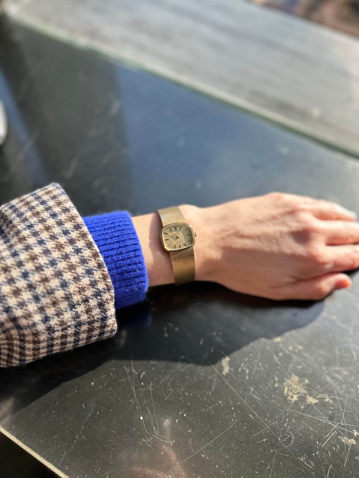 Gold Omega De Ville watch on arm