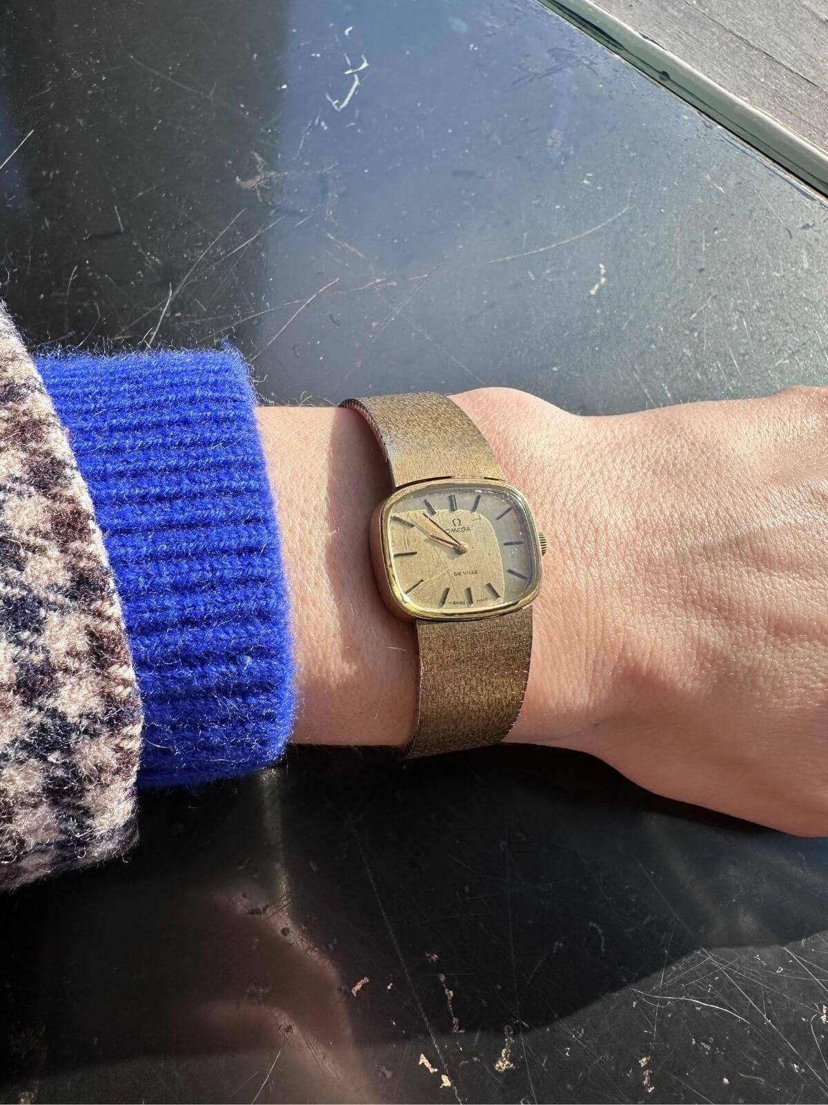 Louise Row Studio featuring Gold Omega De Ville watch on arm close up