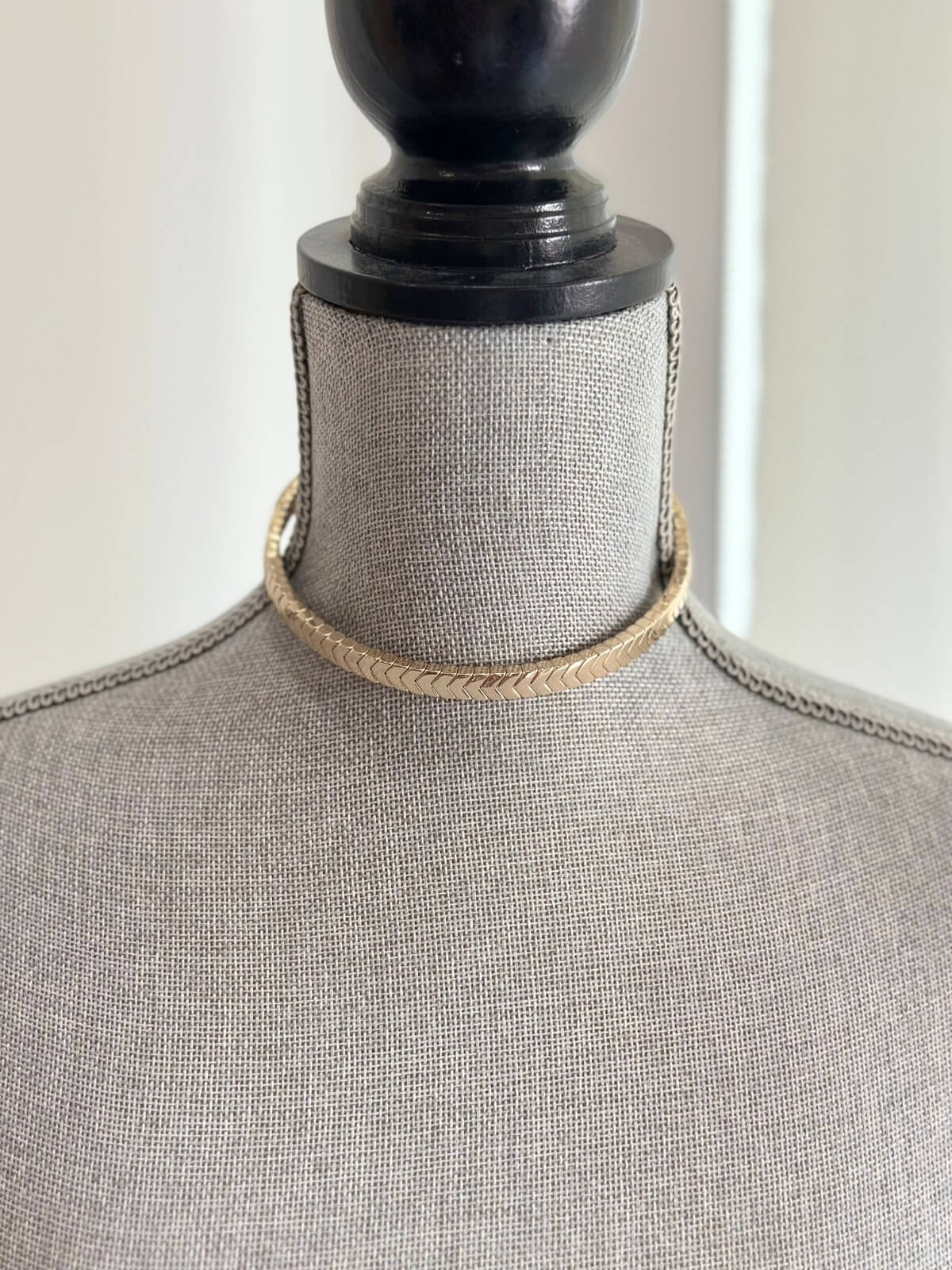 Louise Row featuring Roxanne Assoulin gold choker on grey mannequinn