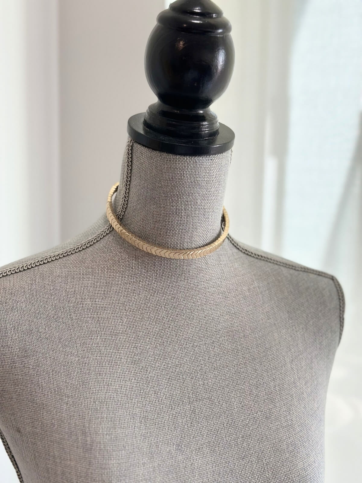 Louise Row featuring Roxanne Assoulin gold choker on grey mannequinn