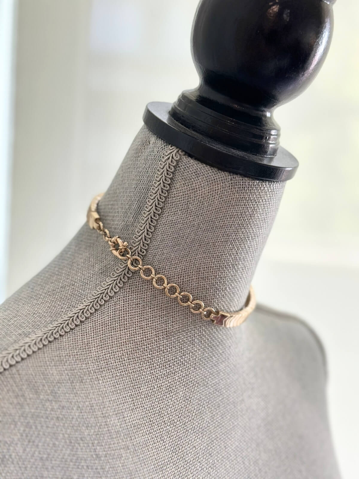 Louise Row featuring Roxanne Assoulin gold choker on grey mannequin