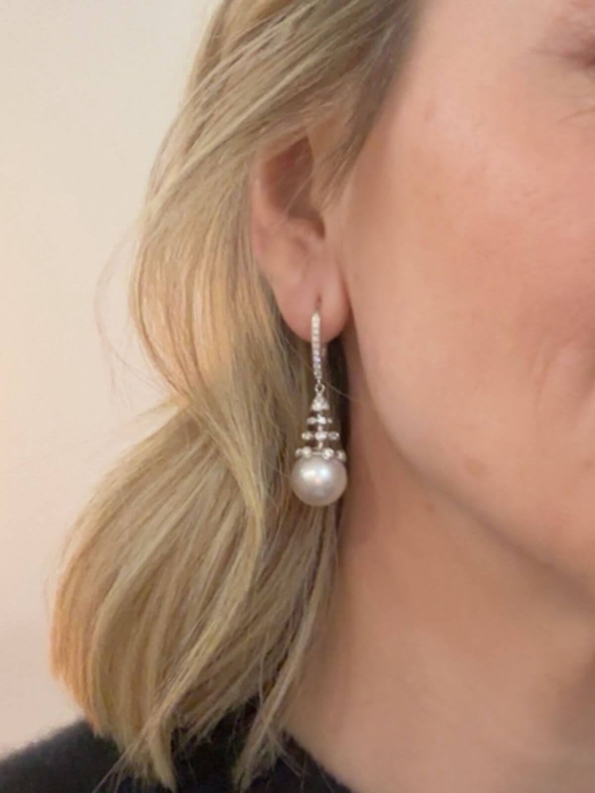 Pearl earring worn by a person with a neutral background