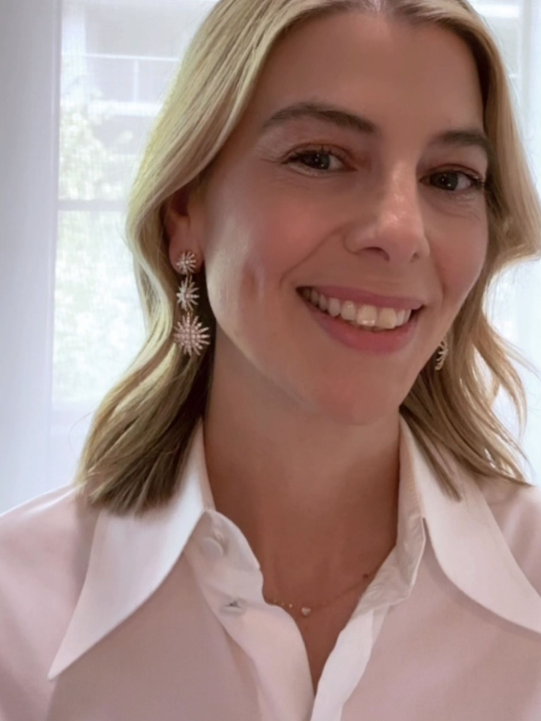 Louise Row Studio David Yurman 18K and diamond Starburst earrings, 3 drop convertible design on close-up of models ear.