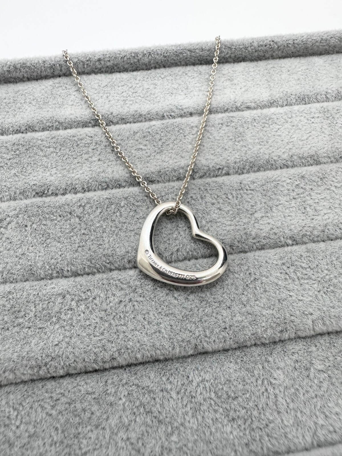 Back side showing signature of Tiffany open heart necklace