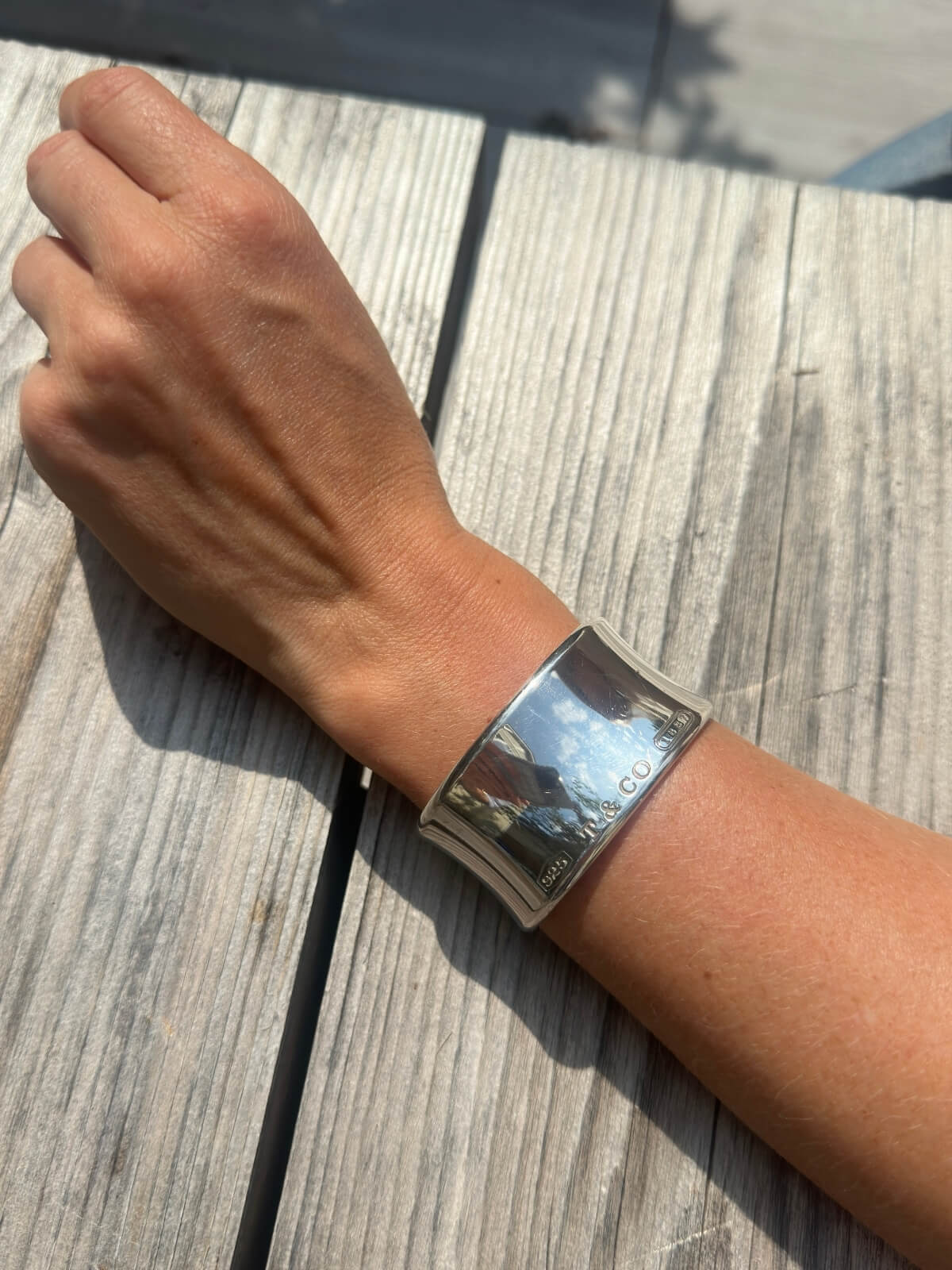 Louise Row Studio featuring Tiffany & Co Silver cuff on model with arm on table