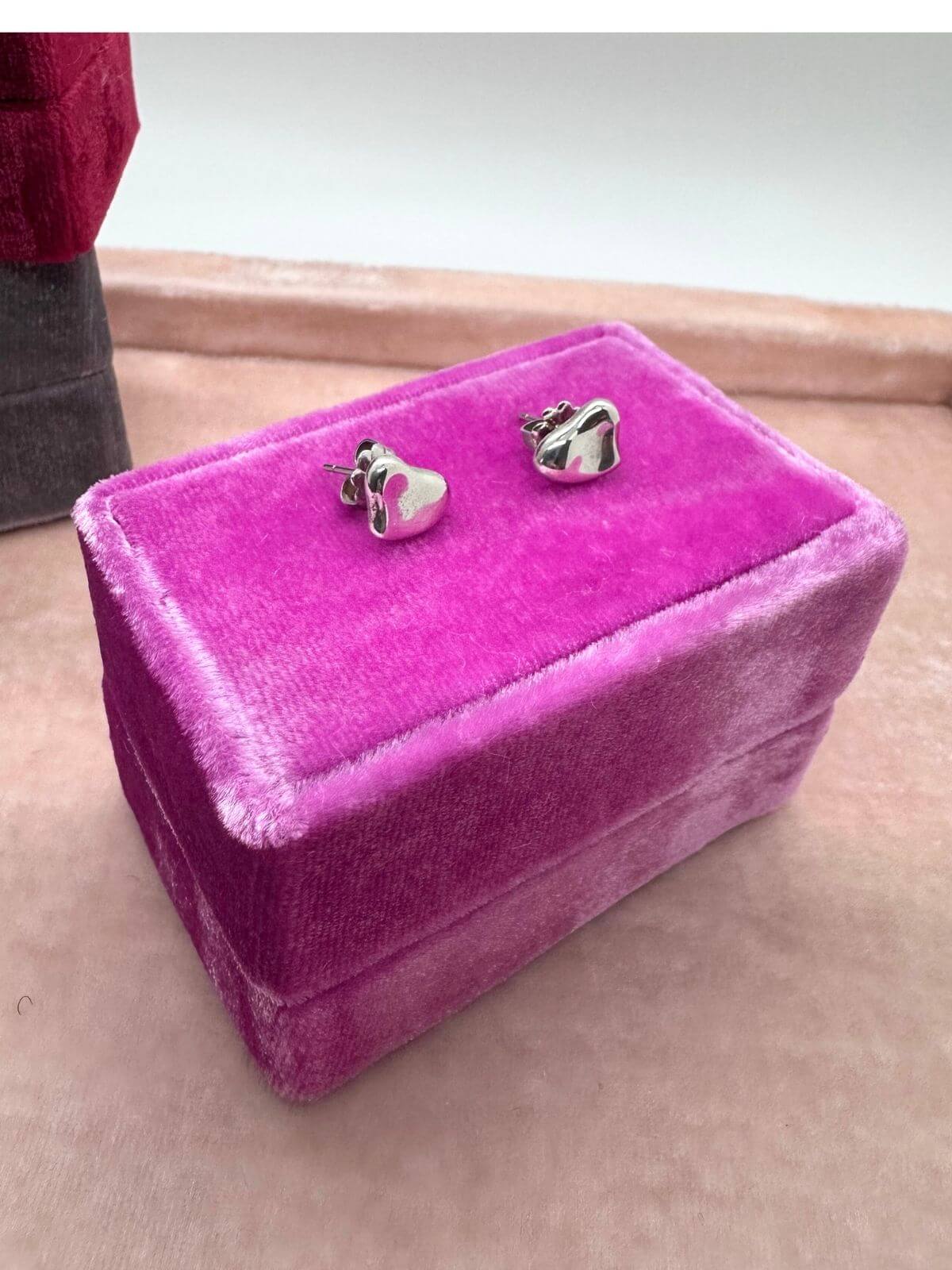 Louise Row Studio featuring Tiffany & Co silver heart stud earrings on pink display box.