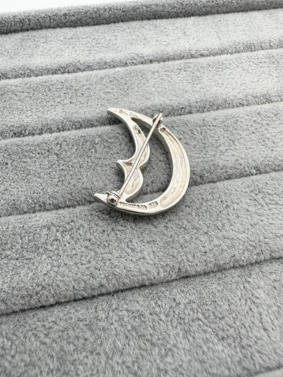 Tiffany moon brooch on grey background showing signature