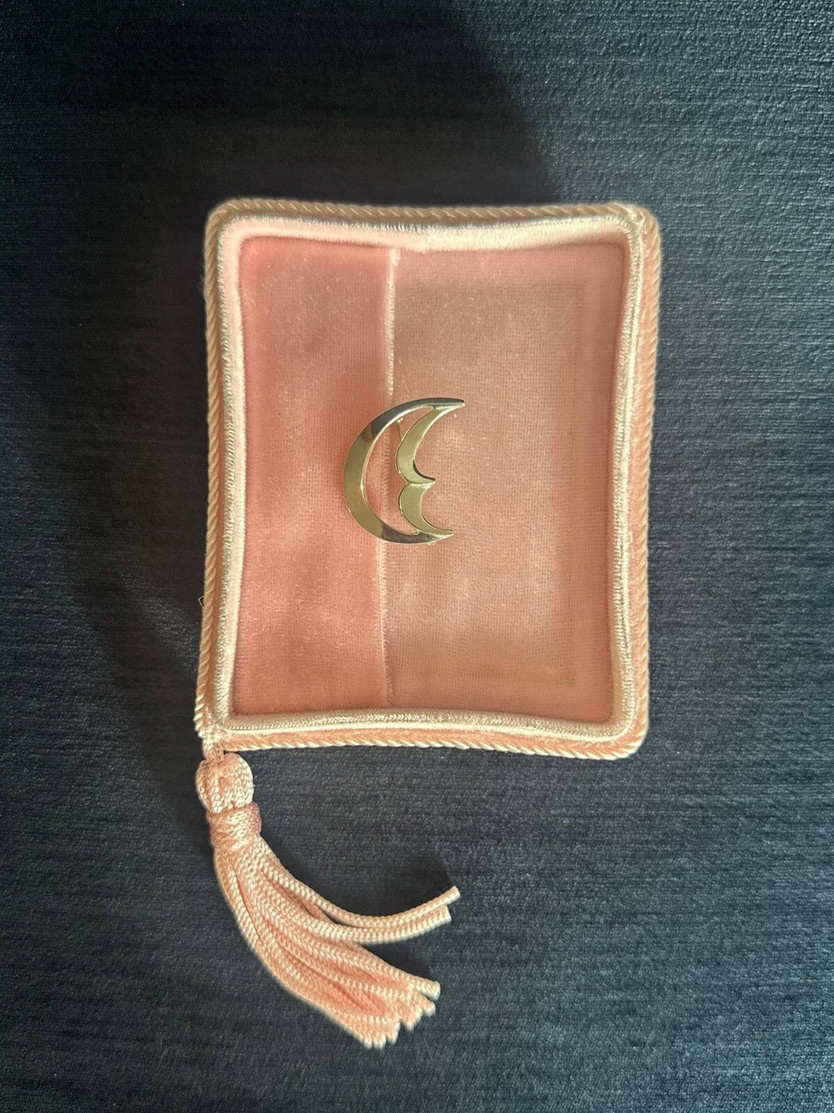 TIffany moon brooch on pink velvet fixture