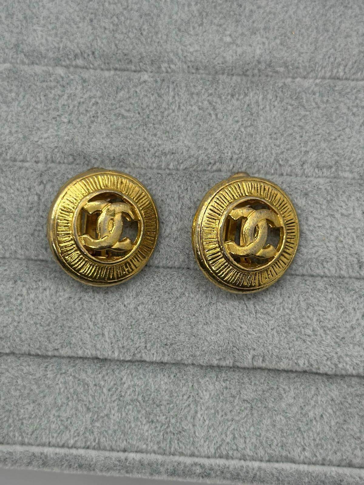 Vintage Gold CC Button earrings on grey background