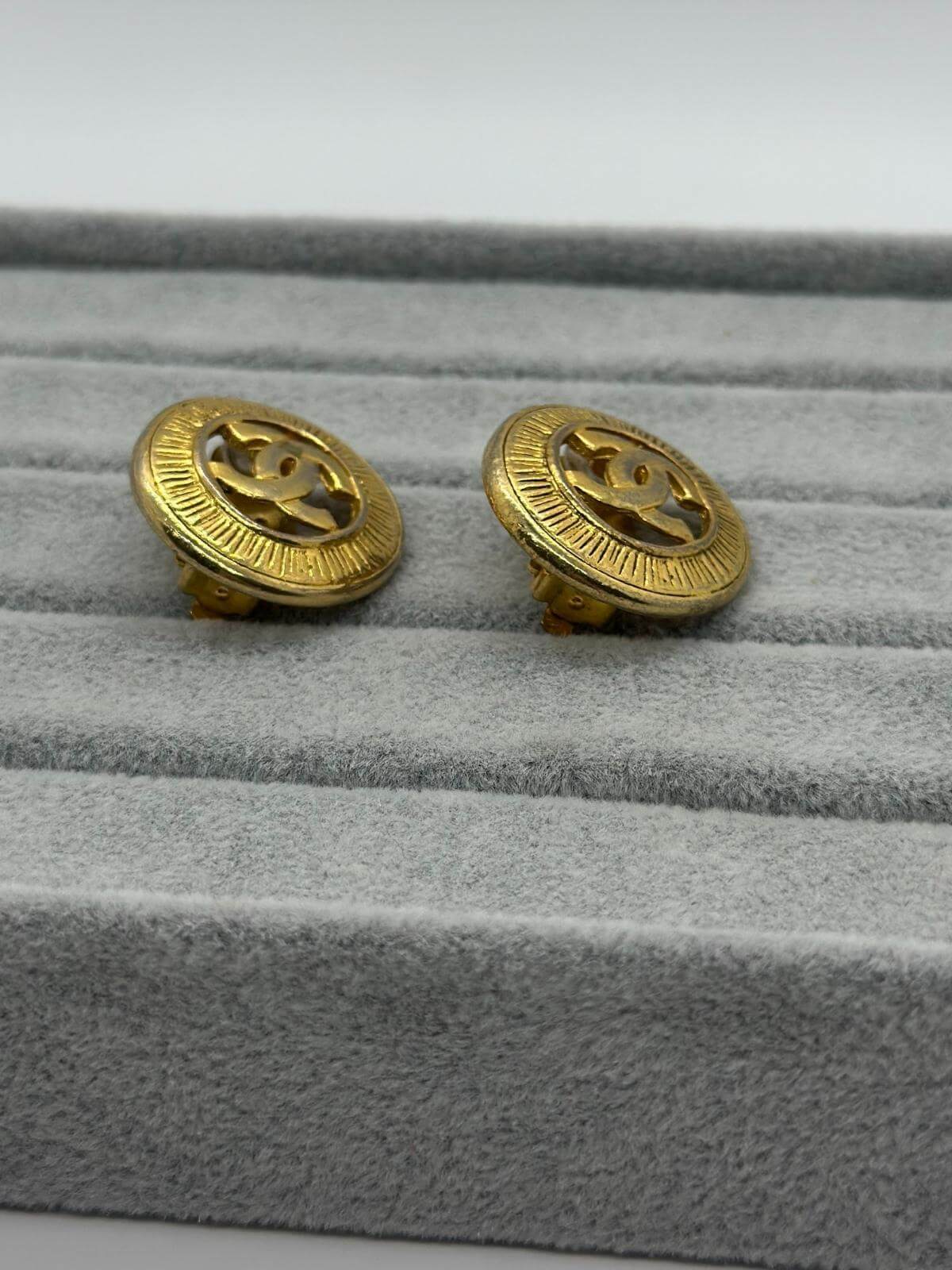 Vintage Gold CC Button earrings on grey background Side