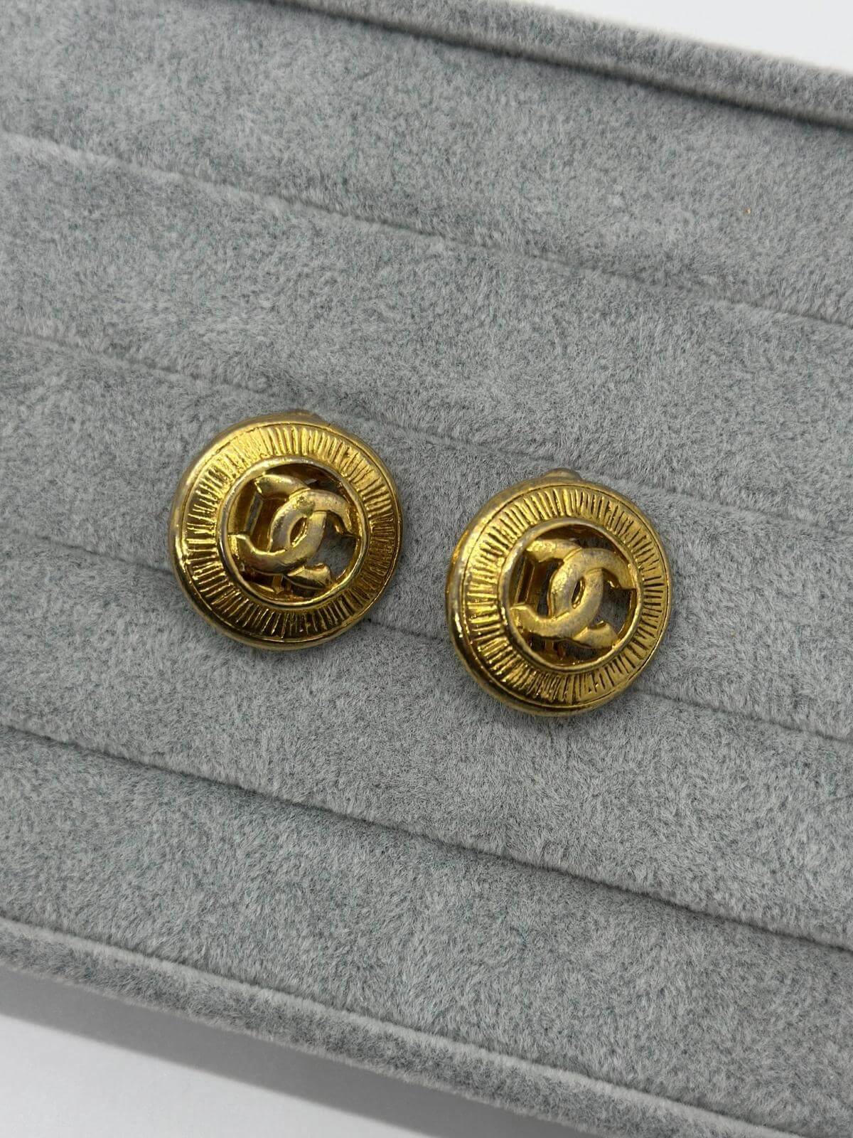 Vintage Gold CC Button earrings on grey background
