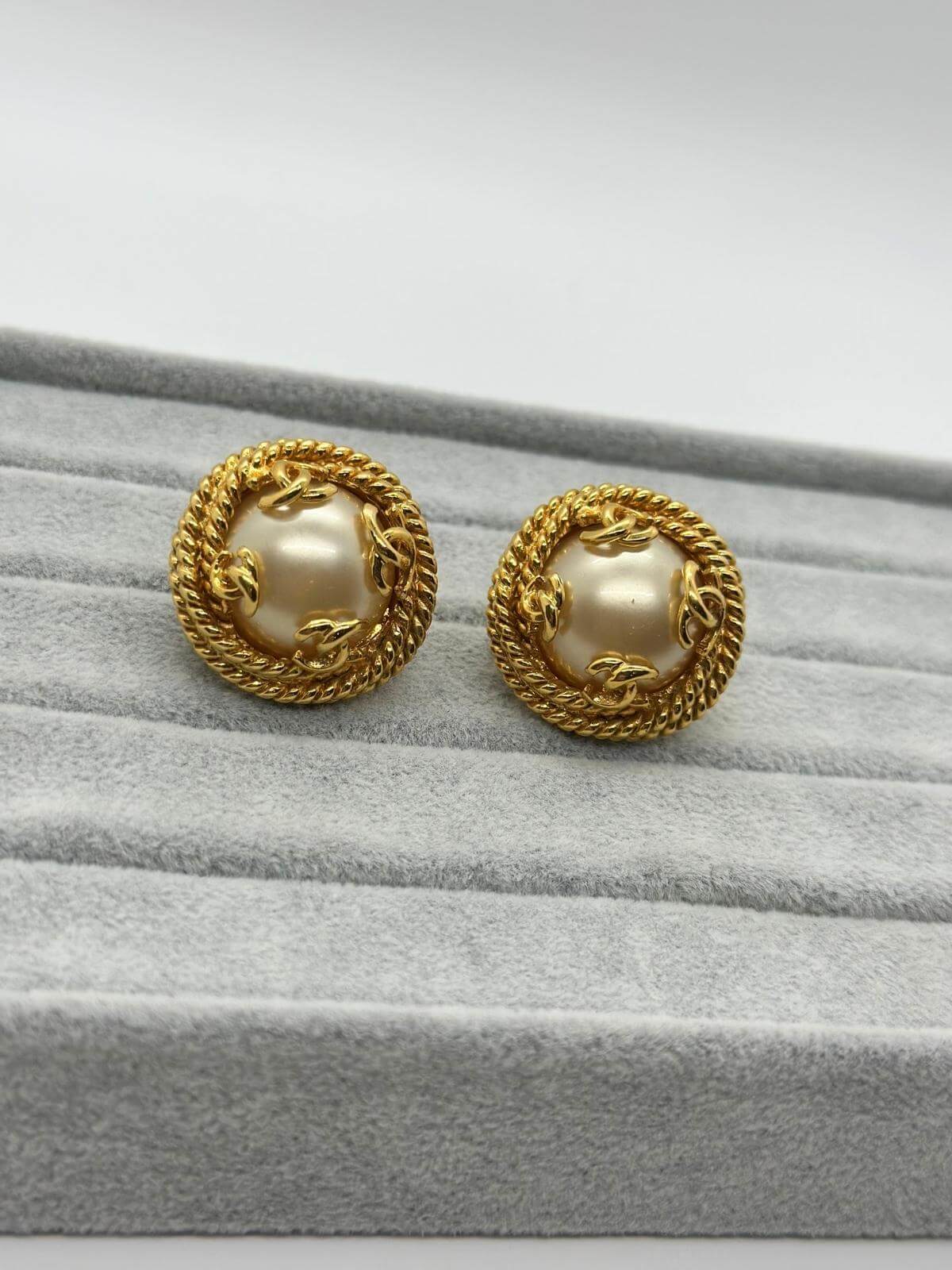 Vintage Changel Pearl and Gold Earring on grey background