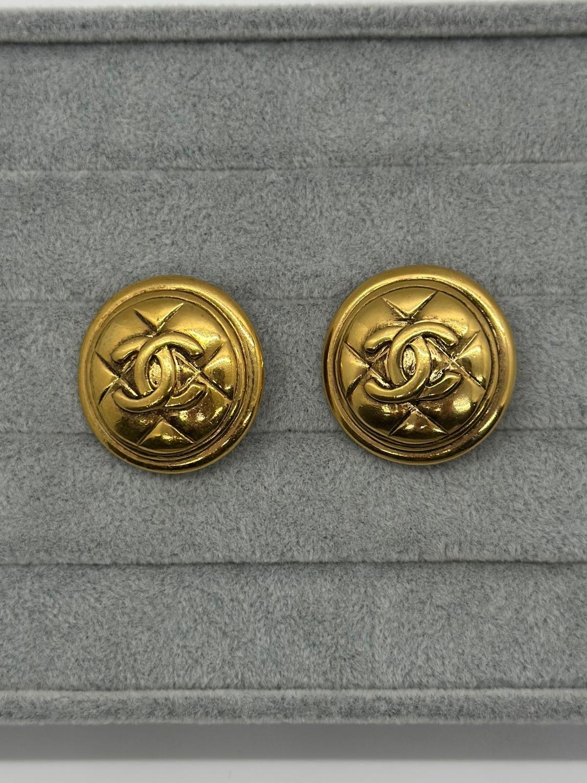 Vintage Chanel Matelasse Round Earrings on grey backround