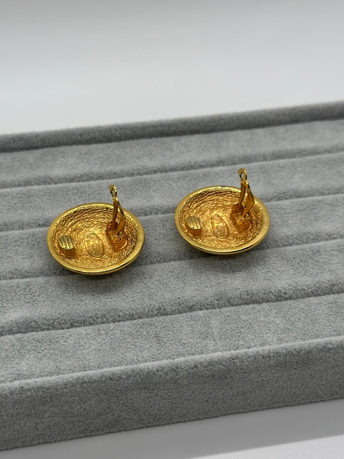 Vintage Chanel Matelasse Round Earrings on grey backround , side view