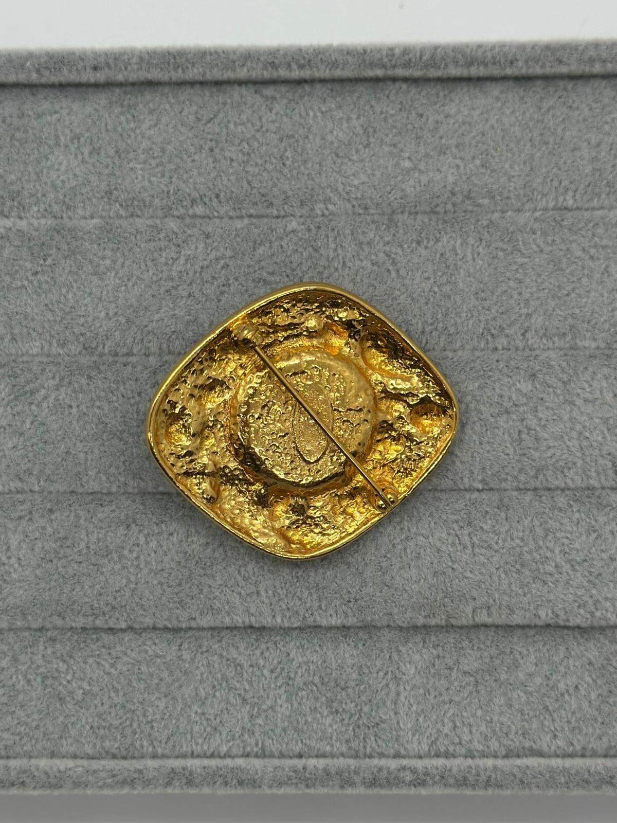 VIntage Chanel Turqoise Brooch on grey background back view of pin