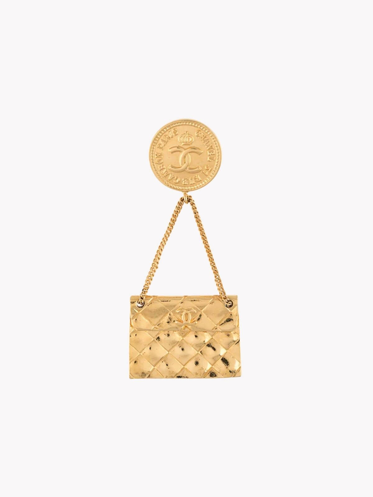 Louise Row Studio vintage Gold Chanel handbag brooch with a CC pendant on a white background