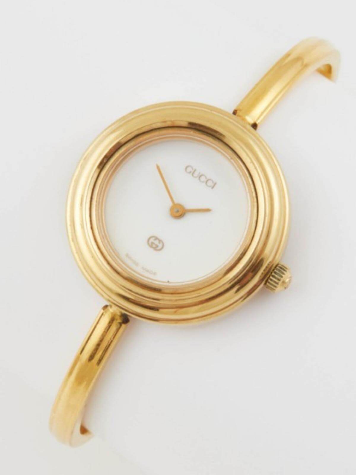 Vintage Gold Gucci watch on a white background