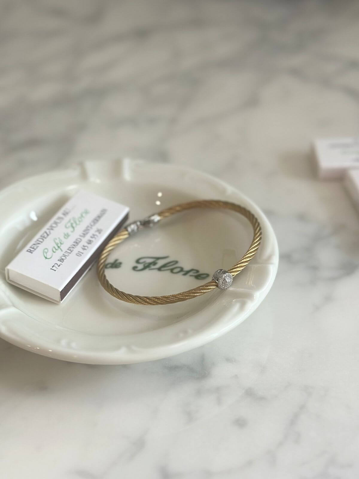 Louise Row Studio featuring Alor cable bracelet on plate on grey table