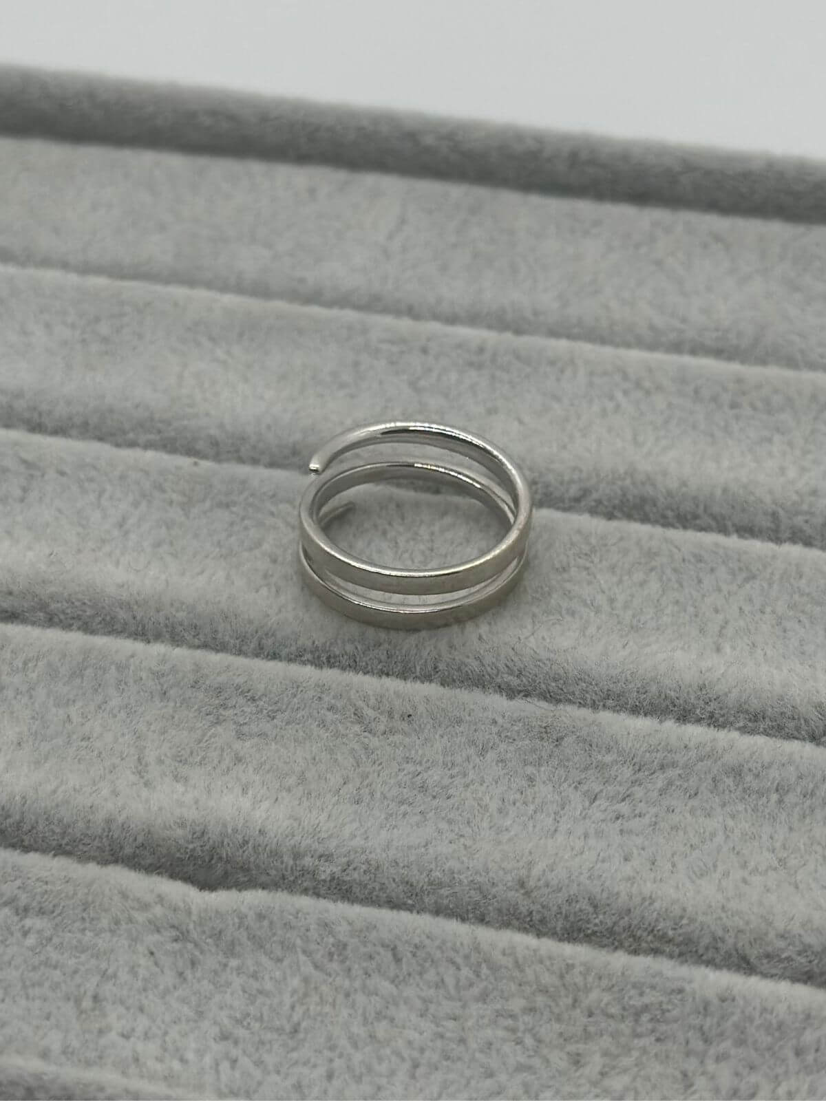 Anita Ko white gold coil ring on grey fixture. 