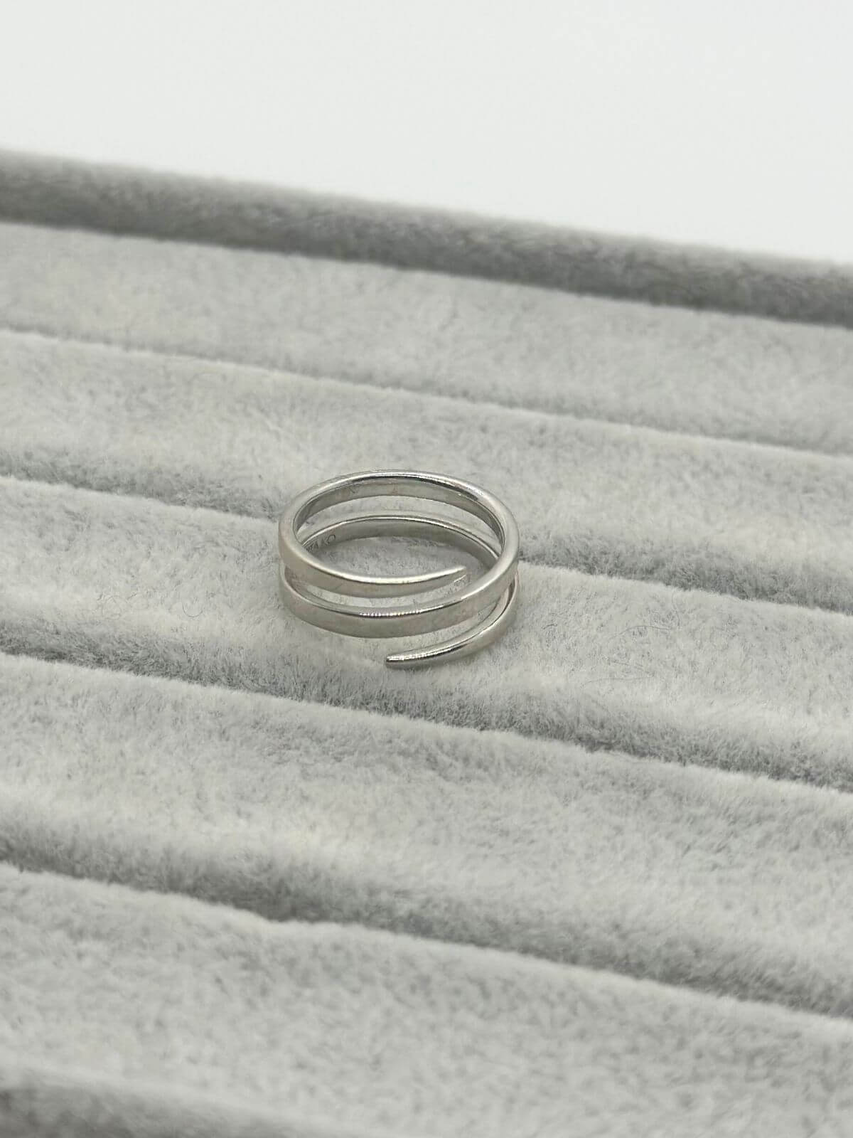 Anita Ko white gold coil ring on grey fixture. 