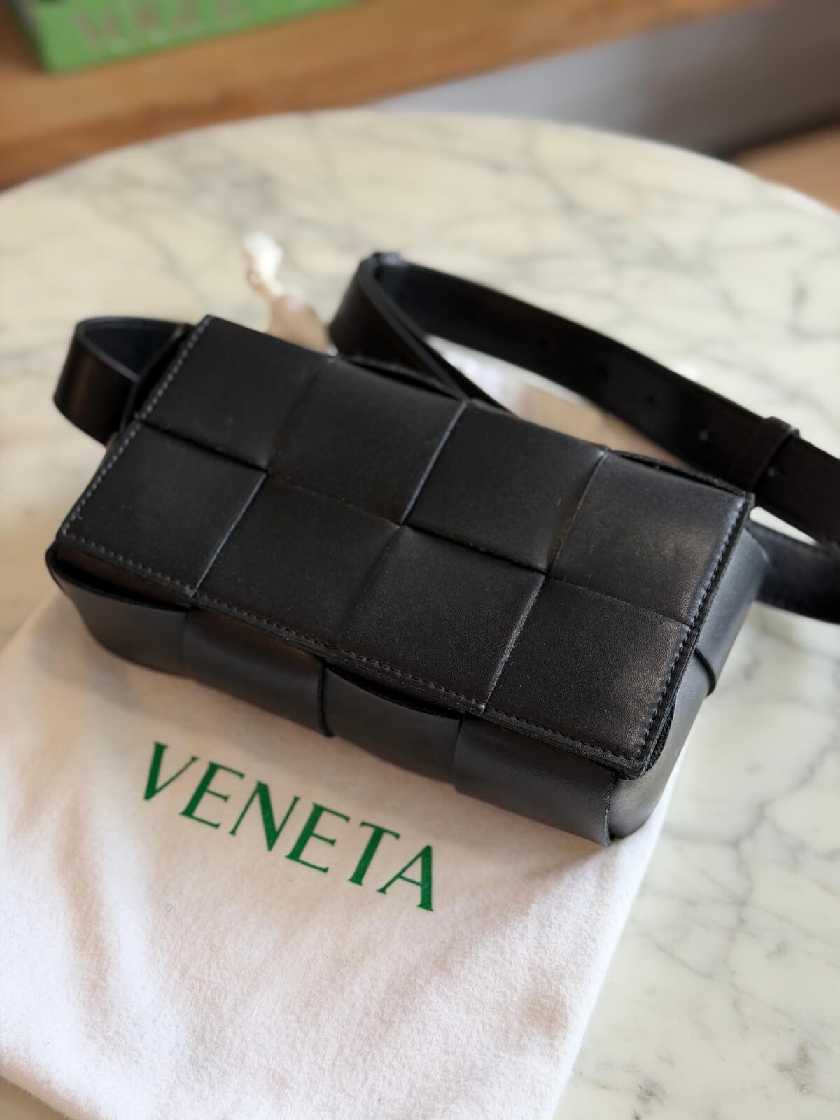Louise Row featuring Bottega Cassette bag on table