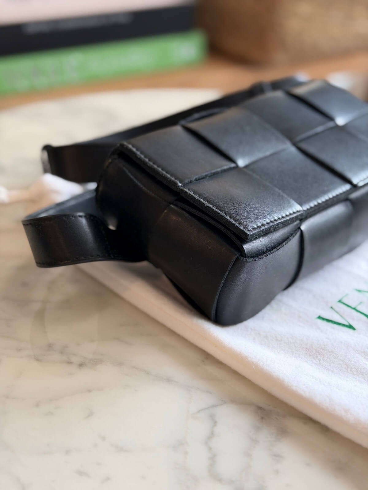 Louise Row featuring Bottega Cassette bag on table