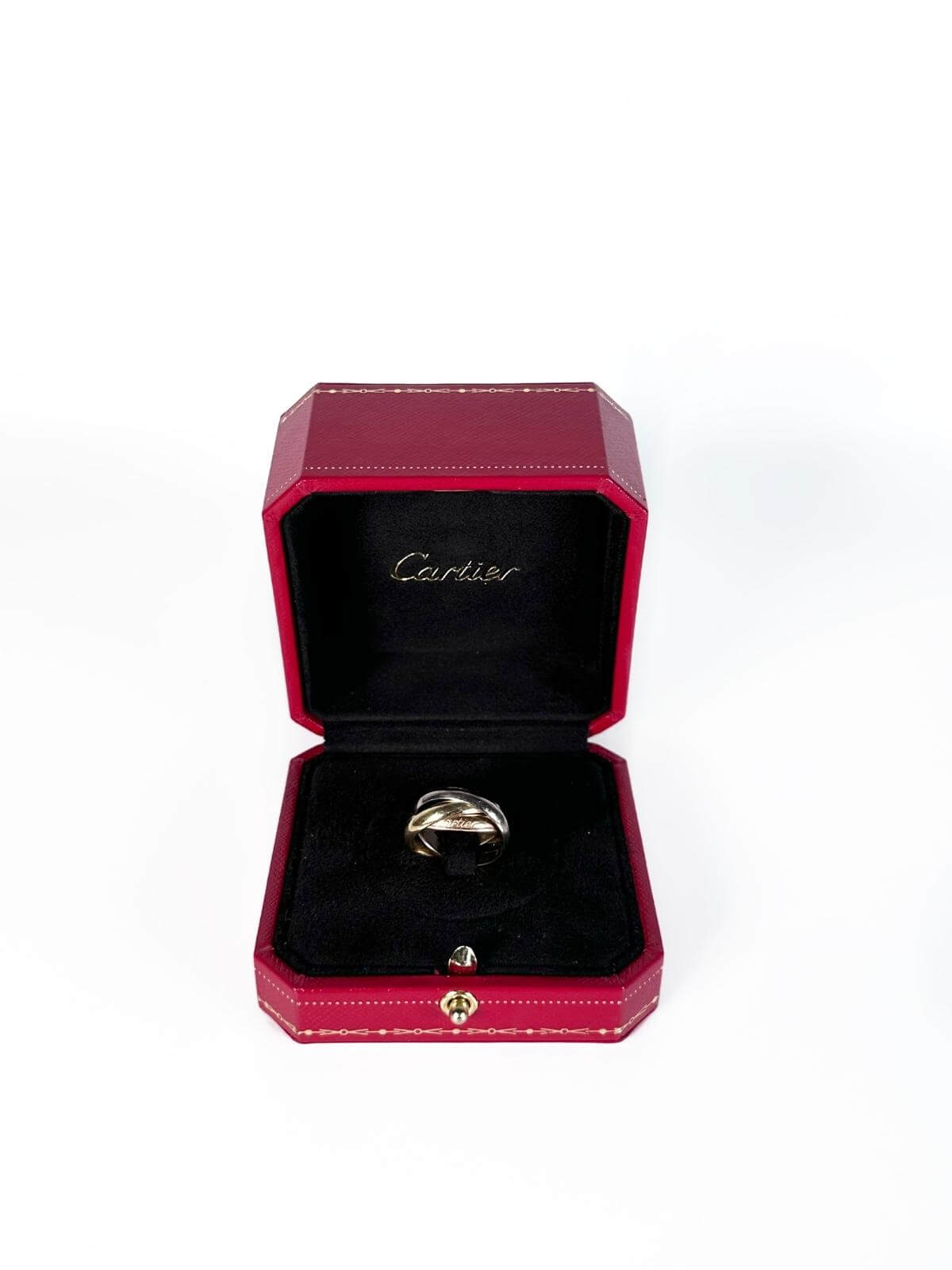 Cartier Gold Trinity  ring in a Cartier jewelry box on a white background