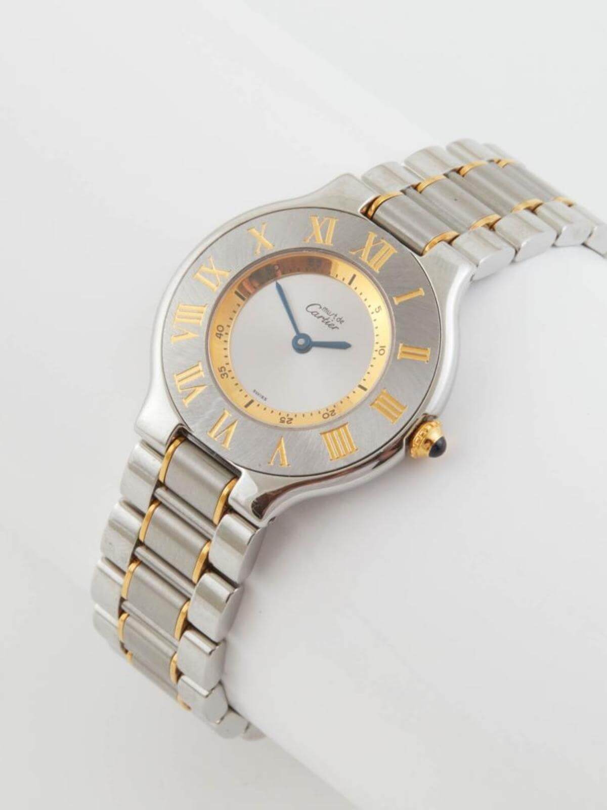 Cartier Silver and gold watch with Roman numeral markers on a light gray background