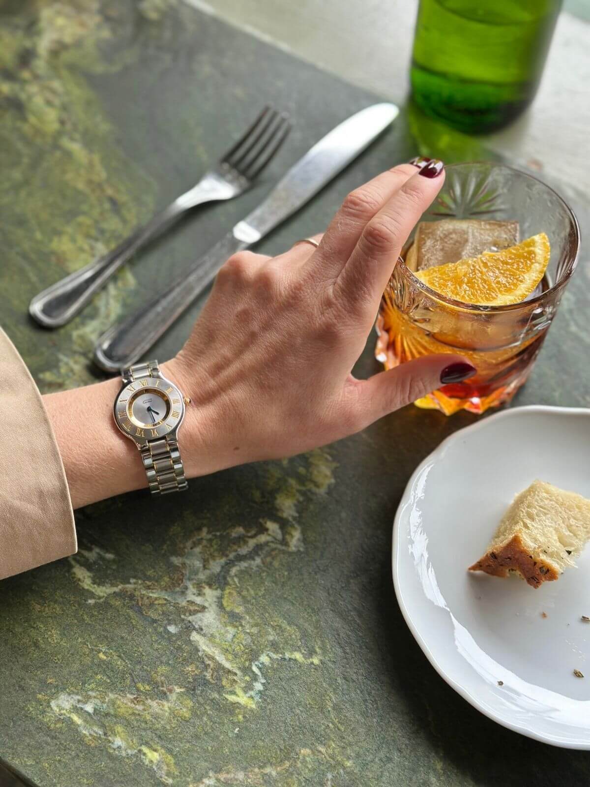Cartier watch on hand with coctail