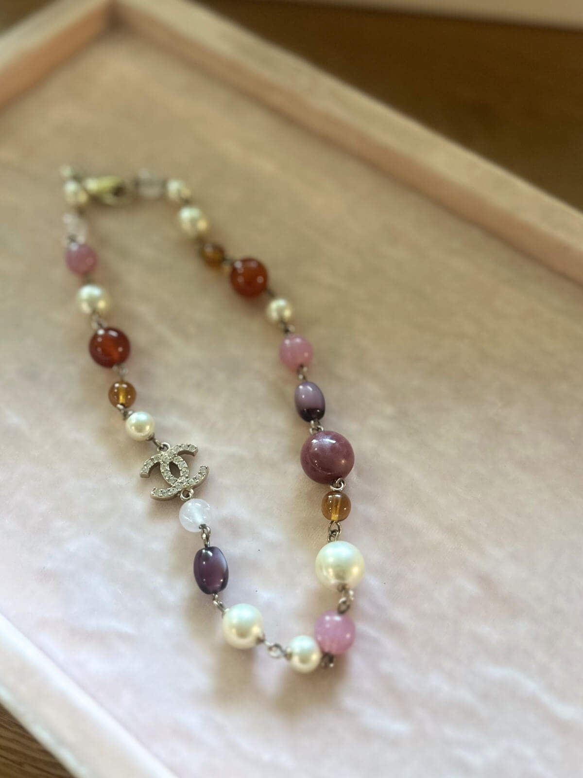 Louise Row featuring Chanel beaded necklace on pink pad