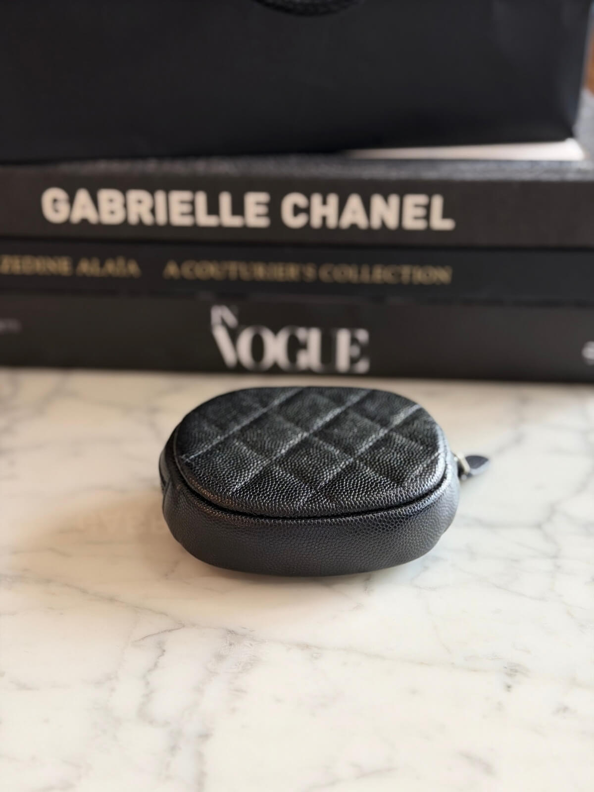 Louise Row featuring Chanel cavier coin purse on table 