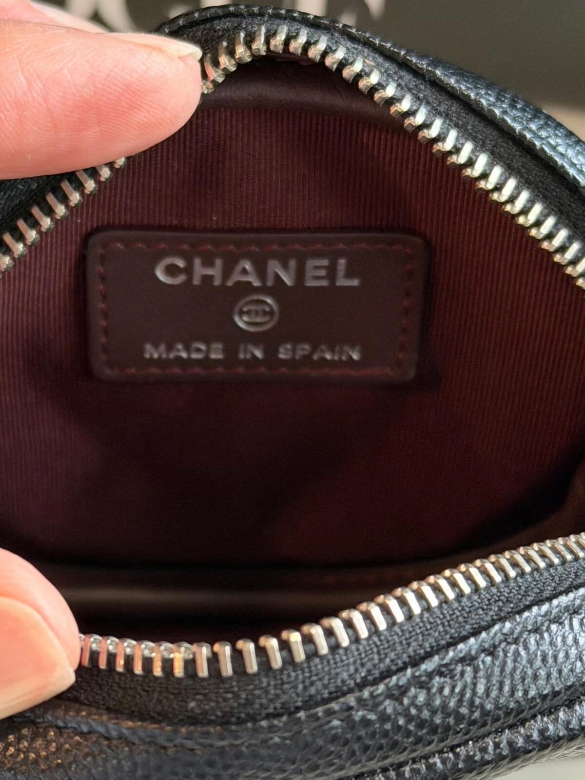 Louise Row featuring Chanel cavier coin purse on table 